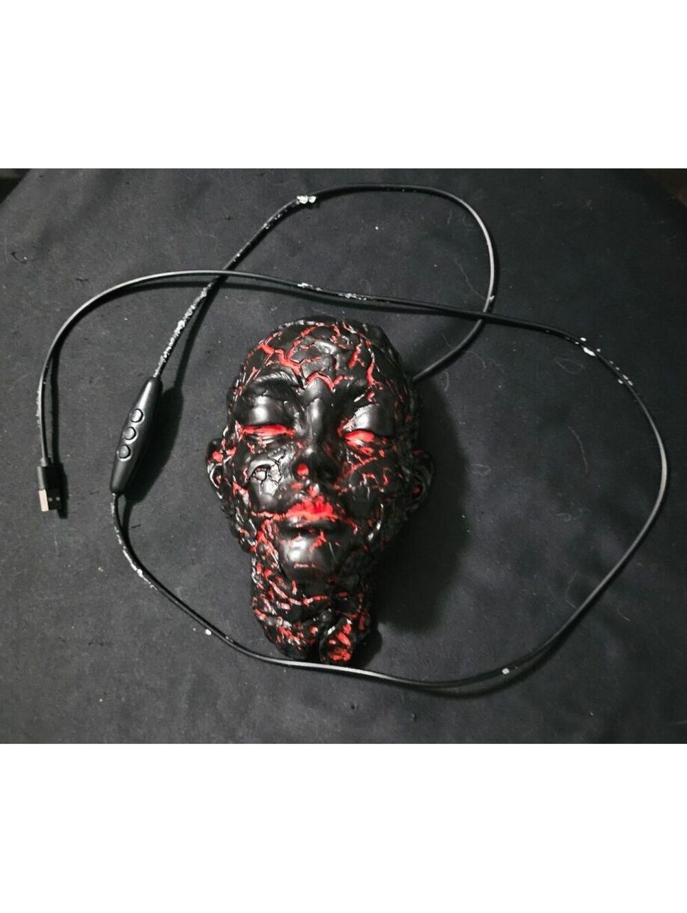 gothic cracked-face wall sculpture black and glowing red LED